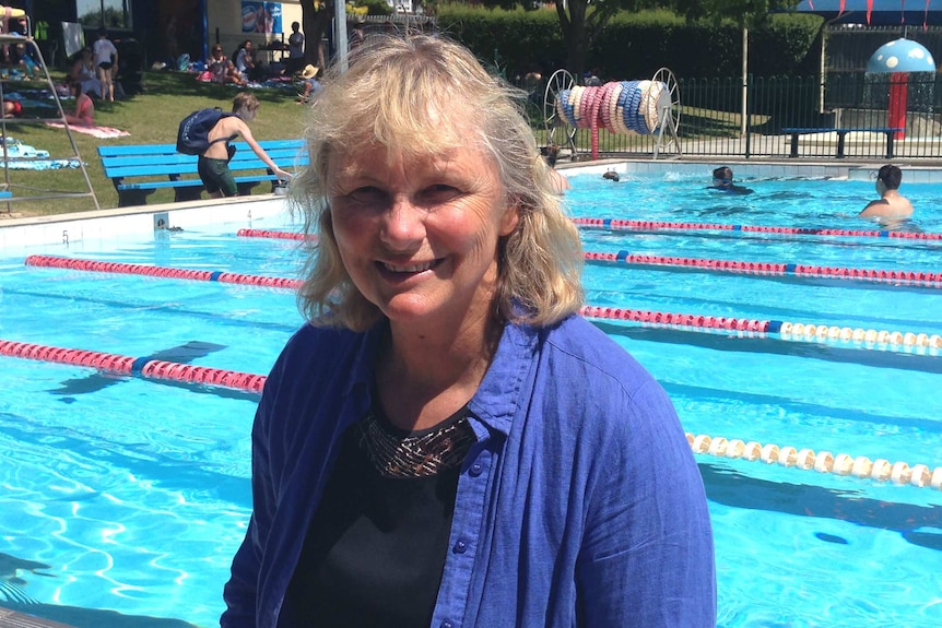 Shane Gould smiles at a swimming pool.