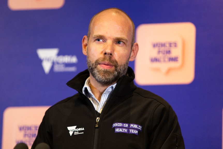 Dressed in a shirt and black polar fleece jacket, Jeroen Weimar hosts a press conference.