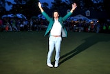 Adam Scott celebrates while wearing his green jacket after winning the 2013 Masters.