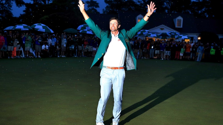 Adam Scott celebrates while wearing his green jacket.