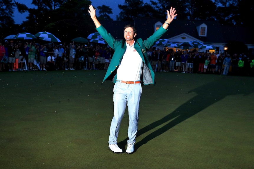 Adam Scott celebrates while wearing his green jacket after winning the 2013 Masters.