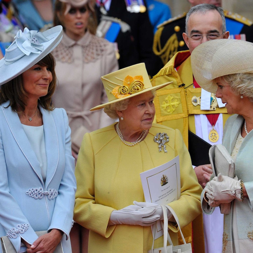 Queen Elizabeth in a cheery yellow, with Carole Middleton, mother of the bride, and Camilla, Duchess of Cornwall.