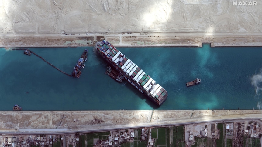 An aerial image of the Suez Canal shows the Ever Given and other vessels
