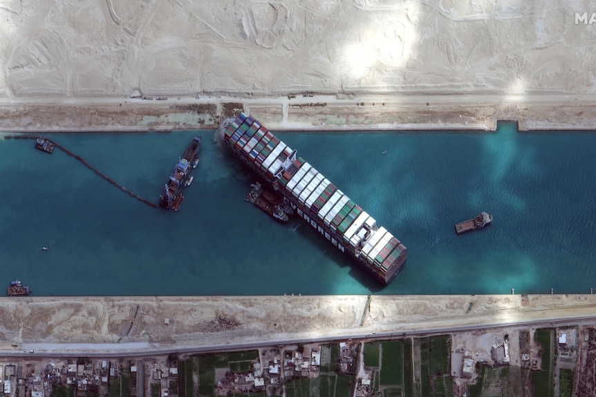 An aerial image of the Suez Canal shows the Ever Given and other vessels