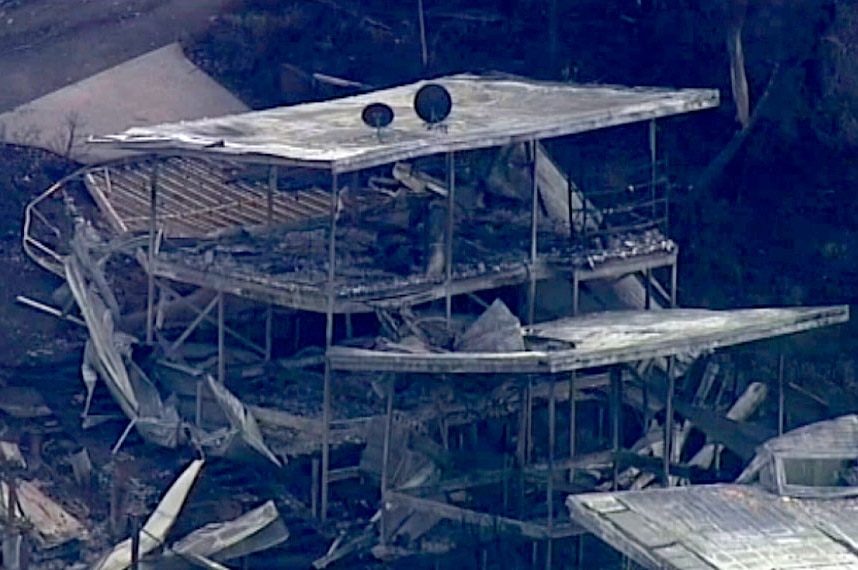 Aerial of damaged two-storey home on the Great Ocean Road