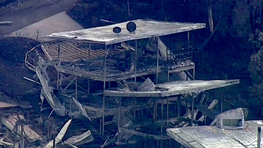 Aerial of damaged two-storey home on the Great Ocean Road