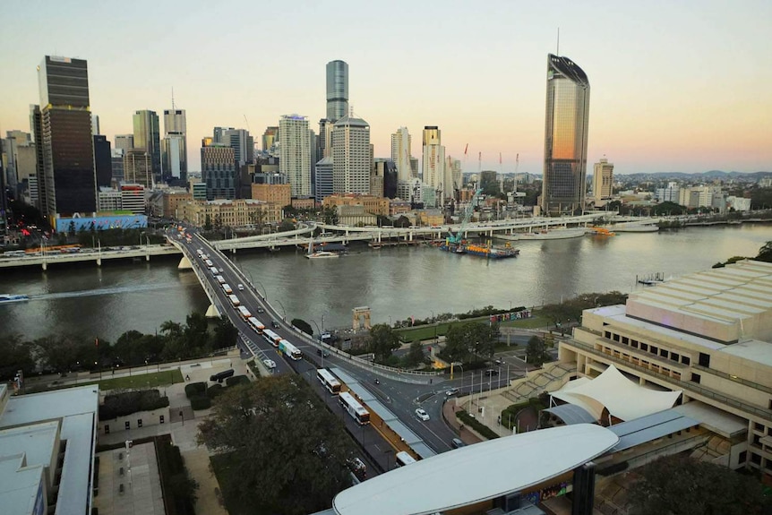 Brisbane city buildings, Victoria Bridge, QPAC, South East Freeway and river at dusk.