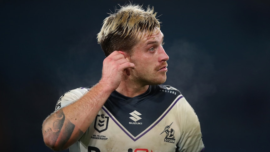Cameron Munster pulls on his ear during Melbourne Storm's NRL game against South Sydney Rabbitohs.
