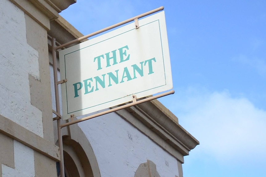 A limestone building with a sign sticking out, reading "The Pennant"