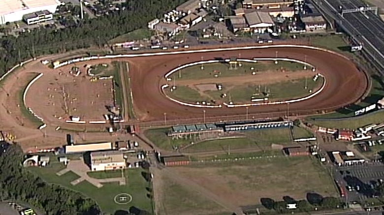 An aerial view of a dirt car racing track.