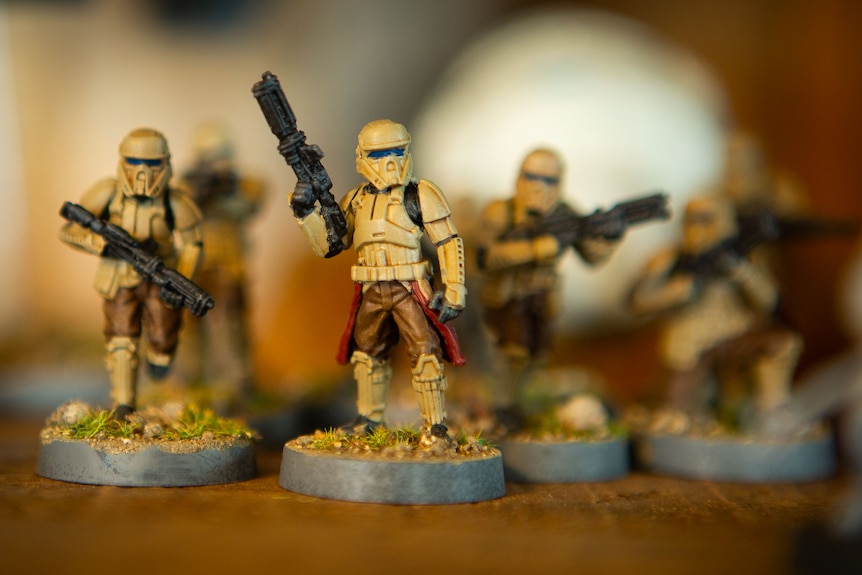 Painted figurines of futuristic soldiers with blasters