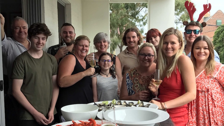 Family smile for a photo with their seafood lunch