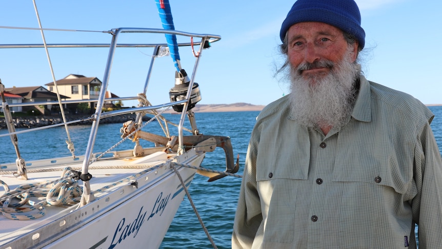 Peter Baggenstos stands by the bow of his yacht bearing the name Lady Lay