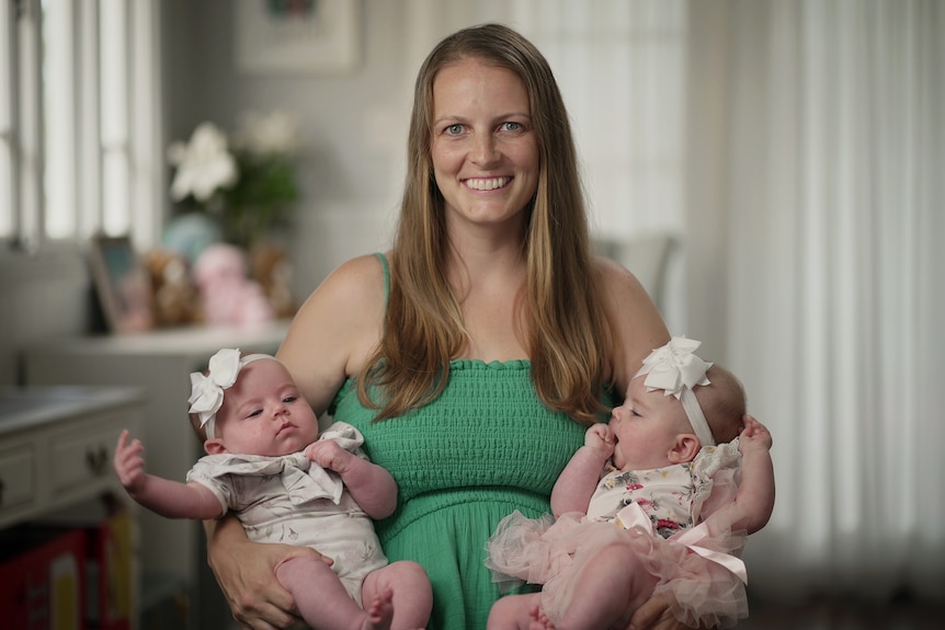 Jacqui Markun holds her twin girls, Elyse and Evelyn,