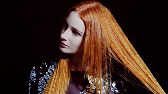 Vera Blue in front of a black background