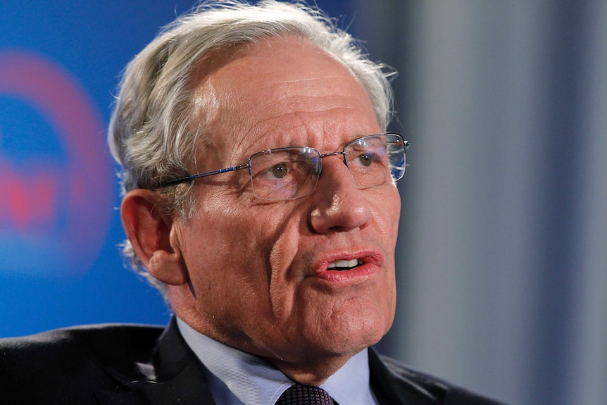 Journalist Bob Woodward, wearing glasses, speaks at an event.