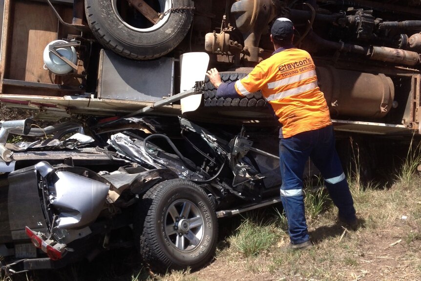 A nine-tonne motorhome flipped and landed on top of the ute with four people inside.