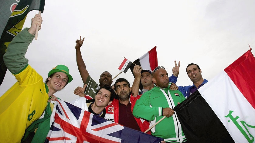 Australia and Iraq fans mingle outside Lang Park in Brisbane.