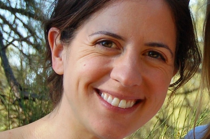 Close up of Kate Smolksi, chief executive, Nature Conservation Council with bushland in the background