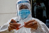 A health worker labels a test-sample tube during the coronavirus outbreak in Hanoi