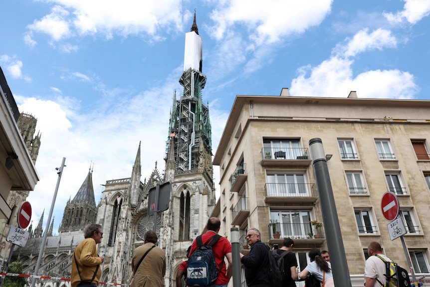People look at the Notre-Dame de Rouen Cathedral