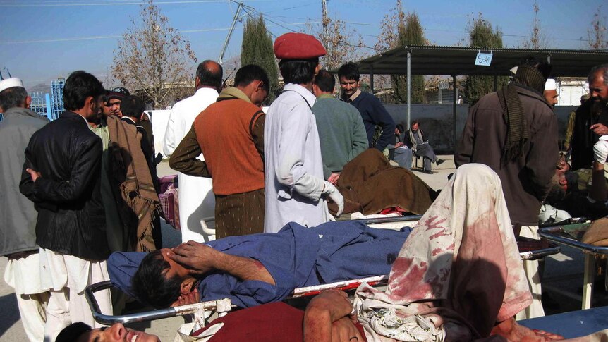 Pakistani paramedics treat injured victims of the bombing