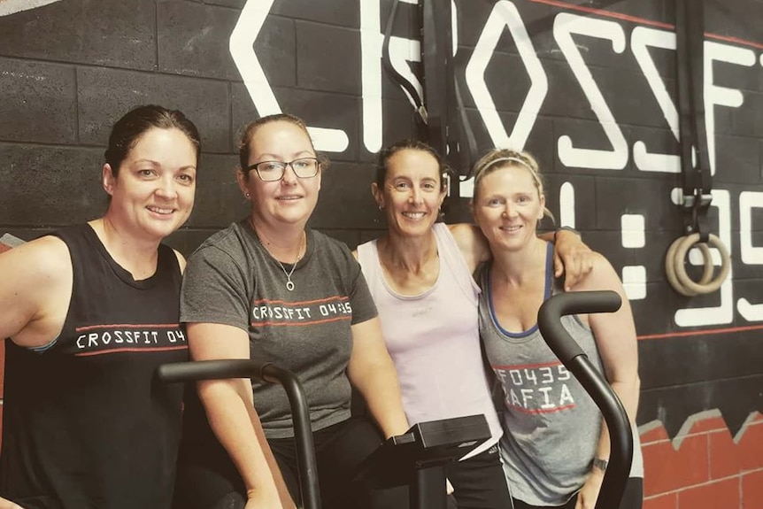 Four members of CrossFit 0435 in New Zealand standing together after finishing Hannah's Tribute Workout of the Day.