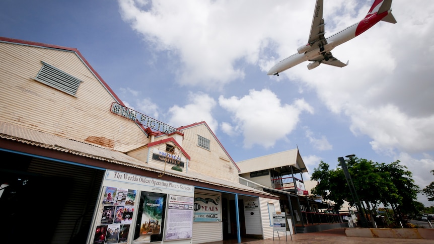 A plane passes over the iconic Sun Pictures movie theatre in Broome