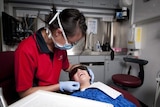 Dentist and child patient from Royal Flying Doctor Service mobile dental service
