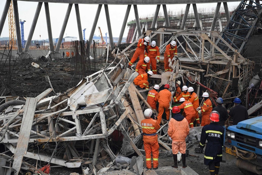 Rescue workers look for survivors among the wreckage of a collapses platform.