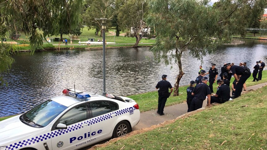 Police on the bank of the River Torrens in Adelaide after man went missing in the water.