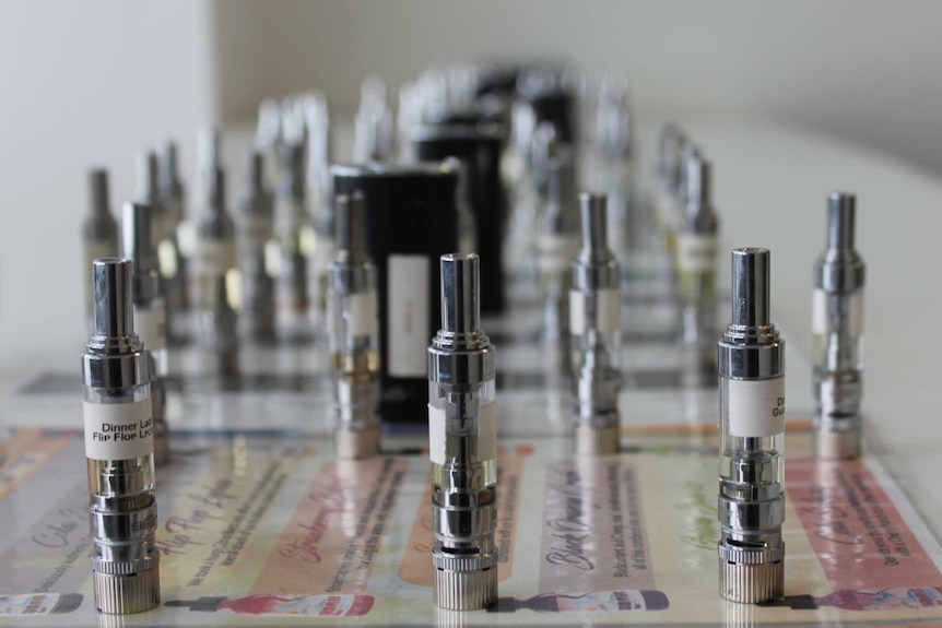 Vaping products lined up on a table.