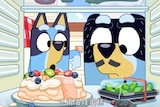two cartoon blue heelers point to a pavlova and box of edamame in their fridge. a jar of vegemite is in the foreground.