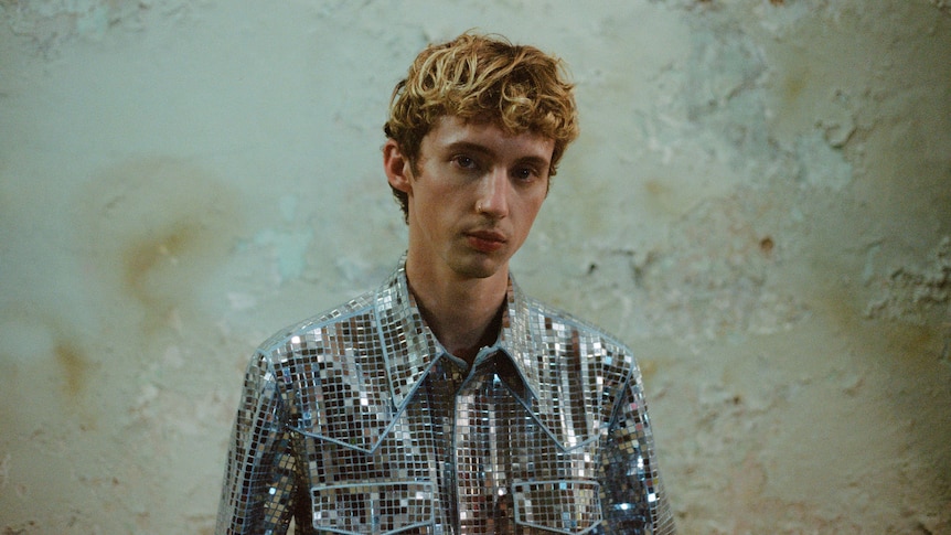 troy sivan wears a sparkly, disco ball button-up shirt