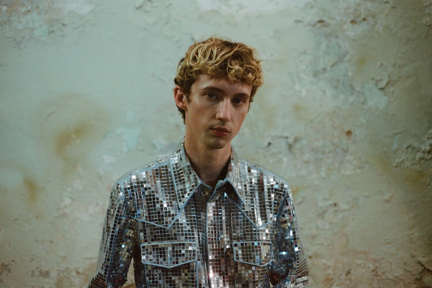 troy sivan wears a sparkly, disco ball button-up shirt
