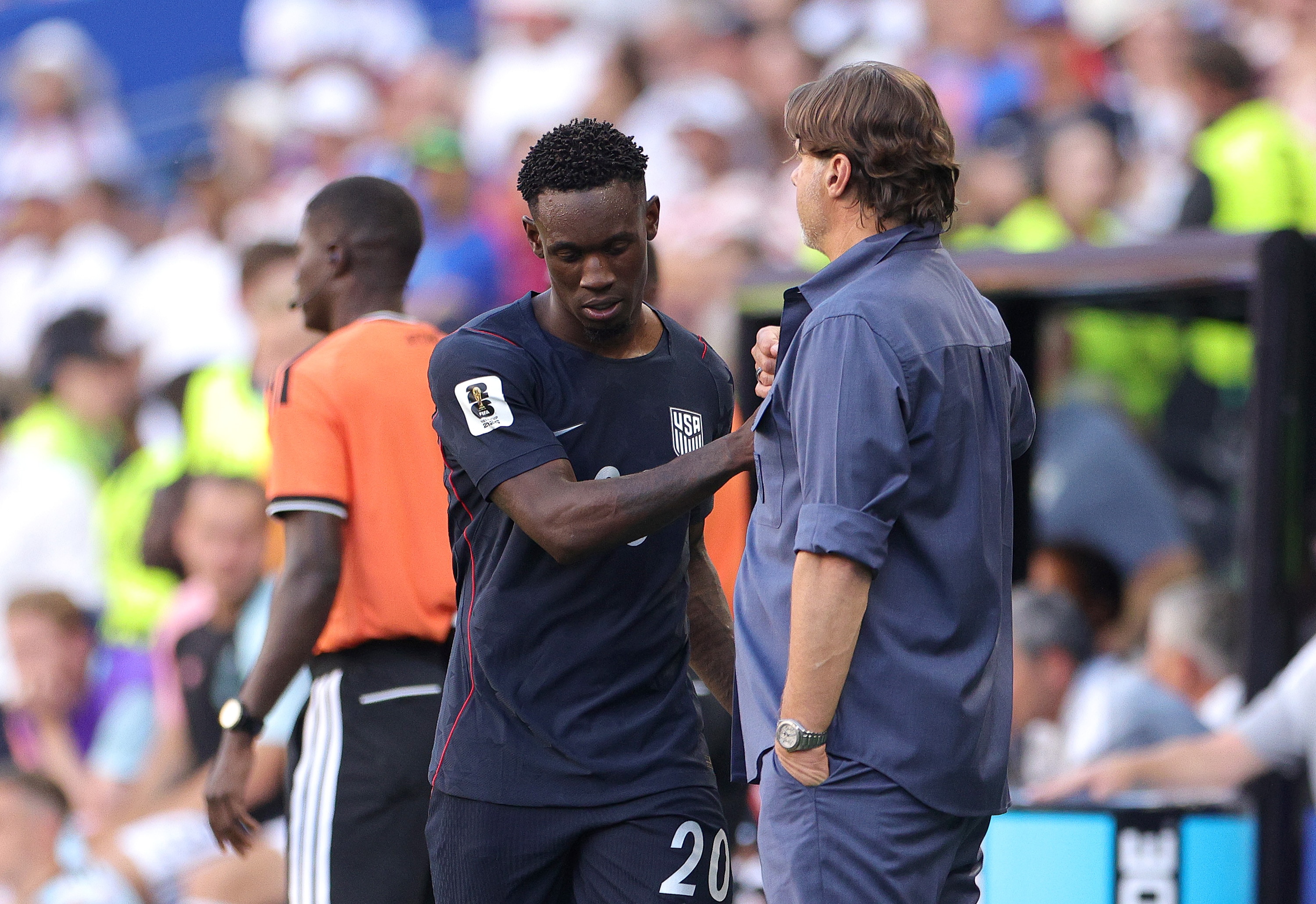 Folarin Balogun of United States shakes hands with coach Mauricio Pochettino.