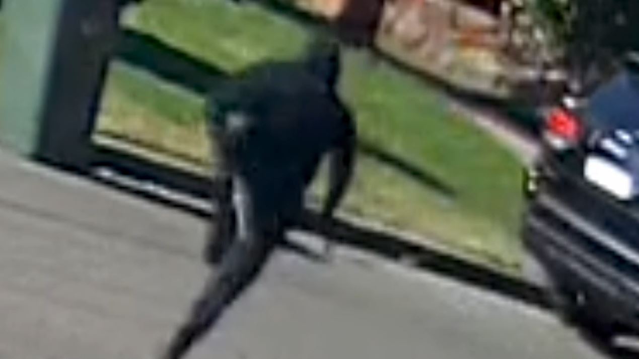 Man dressed in all black holding a gun at shooting of Mahmoud Abbas in Greenacre street