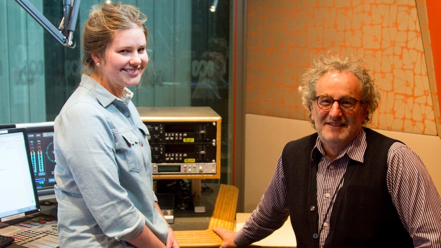 A woman and a man sit in a radio studio