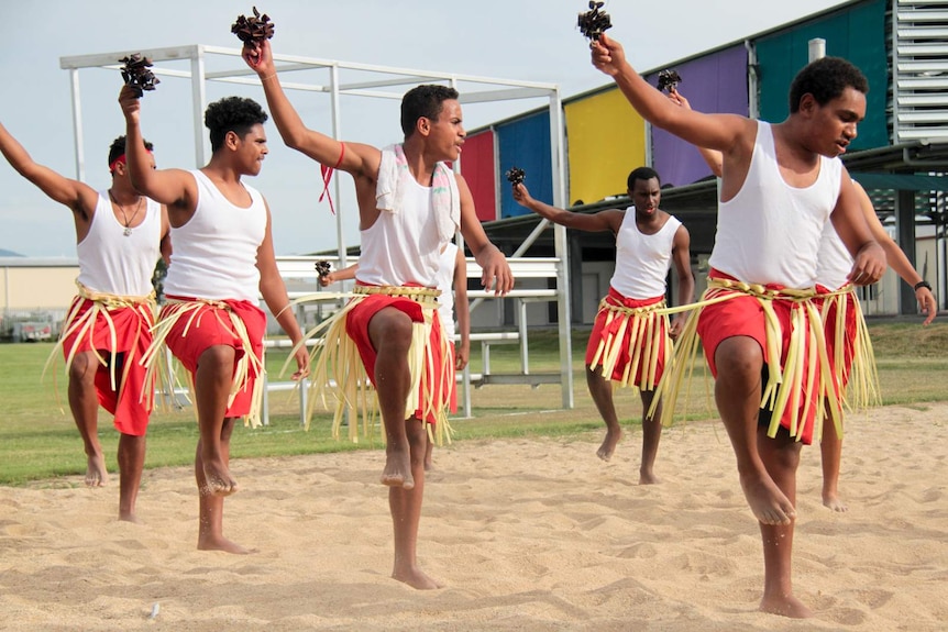 Torres Strait Islander boarders from AFL Cape York House in Cairns perform traditional dance during a fundraising event.