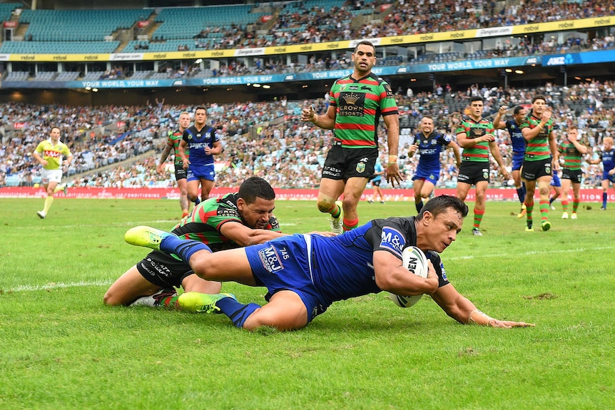 Sam Perrett scores against the Rabbitohs