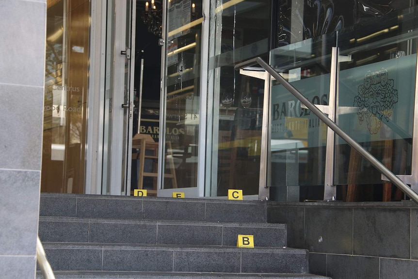 Police markers on steps to a restaurant