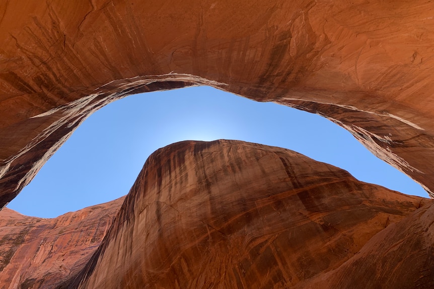 Blue sky behind red rock.