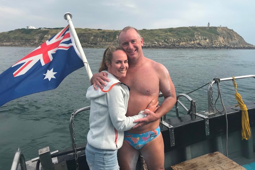 Man and woman on boat with Australian flag