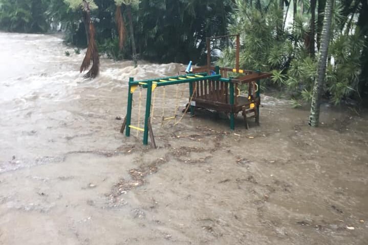 Flooding in the backyard surrounding a playground.
