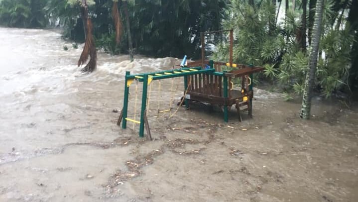 Flooding in the backyard surrounding a playground.