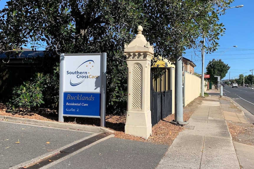 A sign for a nursing home on a main road