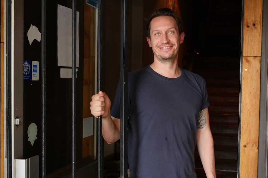 Bar owner Aaron Edwards stands outside his venue on Oxford Street, Sydney.