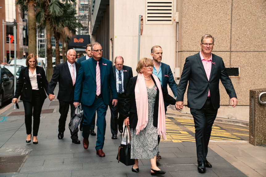 A group of people walking along the street