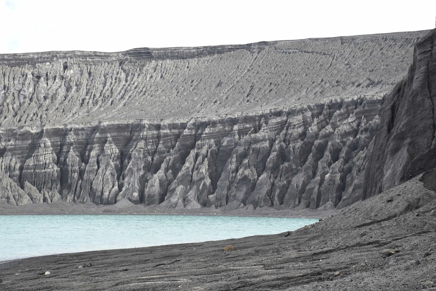 A landscape photograph shows the eroded crater of the volcano.