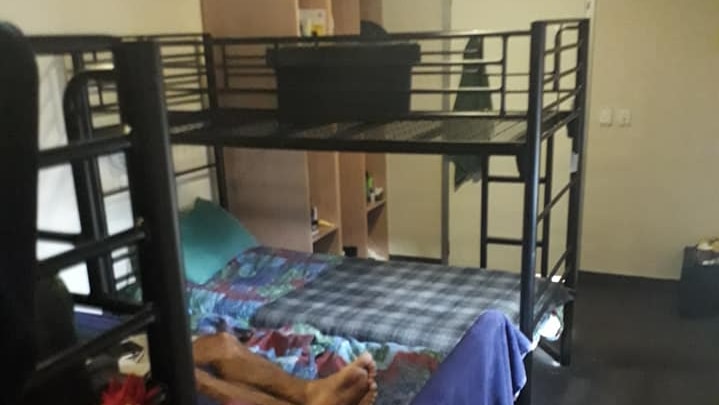 A small room with bunk beds.
